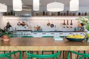 Jersey City apartment for rent - A kitchen with a wooden table and green chairs.