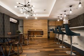 Jersey City apartment for rent - A modern dining room with a wooden floor and a fireplace.
