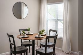 Overland Park apartment for rent - a dining room with a table and chairs and a mirror