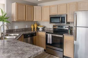 Overland Park apartment for rent - a kitchen with stainless steel appliances and granite counter tops