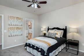 Overland Park apartment for rent - a bedroom with a bed and a ceiling fan