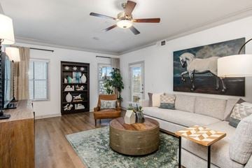 Lenexa apartment for rent - a living room with a couch and a ceiling fan