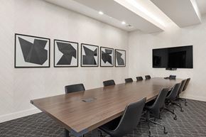 Lenexa apartment for rent - a conference room with a long table and chairs and pictures on the wall