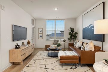 Lenexa apartment for rent - a living room with a couch and a tv