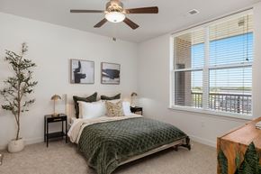 Lenexa apartment for rent - a bedroom with a bed and a ceiling fan