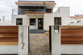 Santa Monica apartment for rent - the front of a house with a driveway and a wooden gate