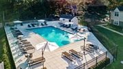Philadelphia apartment for rent - A large outdoor swimming pool surrounded by sun loungers and umbrellas.