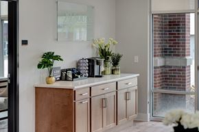 Lincoln apartment for rent - a kitchen with wooden cabinets and a counter with vases and flowers