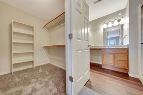 Lincoln apartment for rent - a bedroom with a closet and a bathroom with shelves