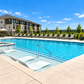 Lincoln apartment for rent - A swimming pool with lounge chairs and a building in the background.