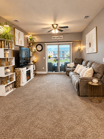 Lincoln apartment for rent - A living room with a grey carpet and a brown sofa.