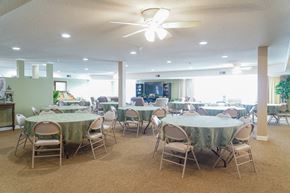 Lincoln apartment for rent - a dining room with tables and chairs and a ceiling fan