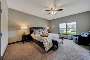 Lincoln apartment for rent - A bedroom with a bed, nightstand, and chair.