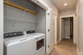 Lincoln apartment for rent - Laundry closet with side by side washer and dryer at Water's Edge at the Woodlands Apartments, Lincoln, NE