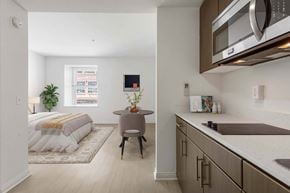 Santa Monica apartment for rent - A modern kitchen with a bedroom in the background.