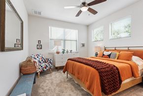 San Antonio apartment for rent - a bedroom with a bed and a ceiling fan