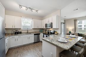 Bradenton apartment for rent - A kitchen with a table set for two.