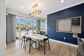 Bradenton apartment for rent - A dining room with a table and chairs and a chandelier.