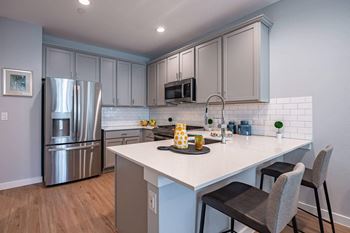 Fitted kitchen with island dining