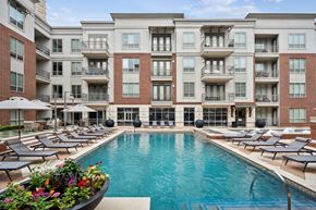 Dallas apartment for rent - a swimming pool in front of an apartment building