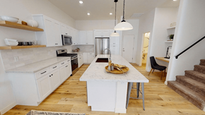 Phoenix apartment for rent - a large white kitchen with a marble counter top at Novella Biltmore, Phoenix, AZ