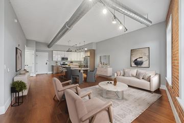Jersey City apartment for rent - A living room with a white couch and a grey rug.
