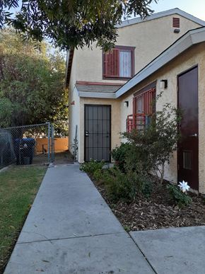 Los Angeles apartment for rent - A house with a brown door and a red window.