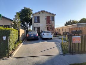 Los Angeles apartment for rent - Two cars are parked in front of a house with a sign that reads "The Artist's Alley.".