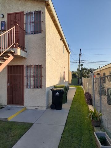 Los Angeles apartment for rent - A building with a red door and a balcony.