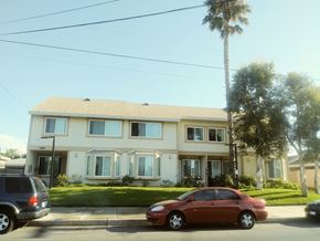 North Hollywood apartment for rent - A red car is parked in front of a two-story house.