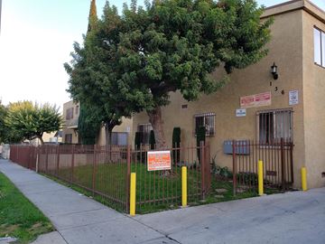 Los Angeles apartment for rent - A brown building with a tree in front of it.