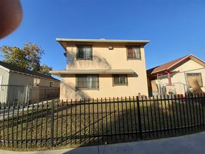 Los Angeles apartment for rent - A two-story house with a black fence in front.
