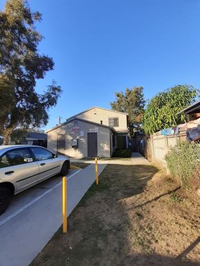 Los Angeles apartment for rent - A white car is parked on the side of a street.