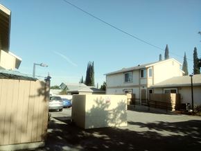 North Hollywood apartment for rent - A sunny day in a residential area with houses and cars.