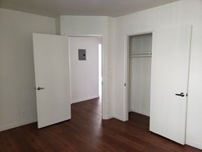 Los Angeles apartment for rent - A room with white walls and wood floors with three doors.