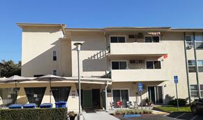 Los Angeles apartment for rent - the exterior of a building with umbrellas in front of it