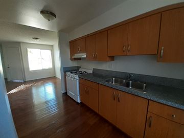 Canoga Park apartment for rent - A kitchen with wooden cabinets and a white oven.