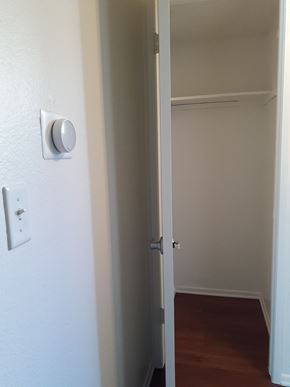 Canoga Park apartment for rent - A white door with a silver handle and a white wall with a switch.