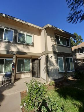 Canoga Park apartment for rent - A sunny day at a residential complex with a building in the foreground.