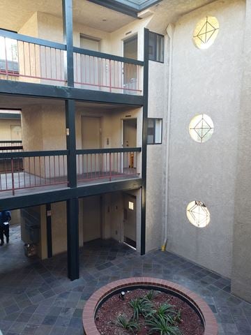 San Pedro apartment for rent - a view of the entrance of an apartment building with a courtyard