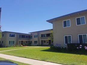 Los Angeles apartment for rent - A building with a green lawn in front.
