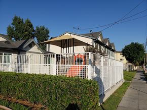 Wilmington apartment for rent - A white fence surrounds a house with a red object in the front yard.