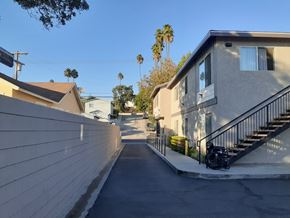 Los Angeles apartment for rent - A residential street with houses on both sides and a clear blue sky.