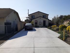 Los Angeles apartment for rent - A car is parked on a driveway in front of a house.