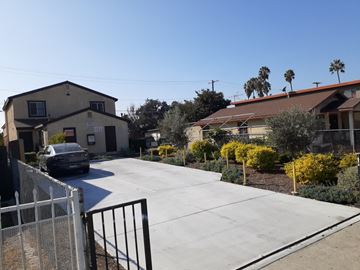 Los Angeles apartment for rent - A car is parked on a driveway in front of a house.
