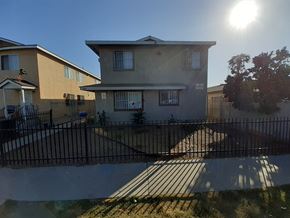 Los Angeles apartment for rent - A sunny day in a residential area with houses and a black fence.