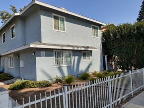 Los Angeles apartment for rent - A grey house with a white picket fence in front.