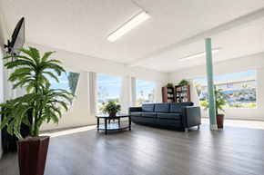 Mission Hills apartment for rent - A living room with a couch, a television, and a potted plant.
