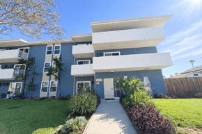 Mission Hills apartment for rent - A modern apartment building with a well-maintained lawn in front.