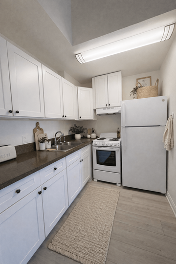 Mission Hills apartment for rent - A kitchen with white cabinets and a white refrigerator.